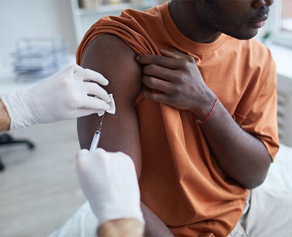 Man receiving injection in shoulder